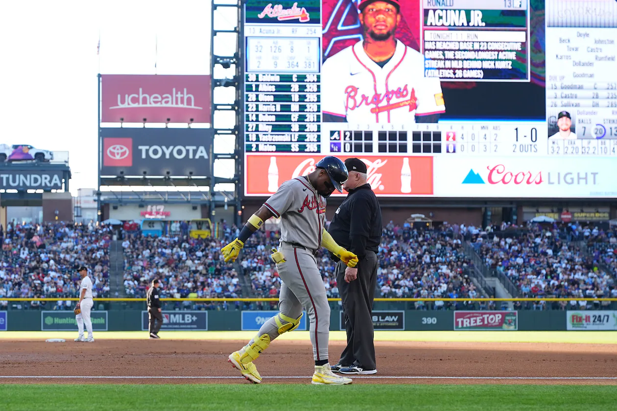 The Braves' Ronald Acuña Jr. (center left) walks gingerly past first base umpire Bill Miller after being injured while running out a groundout in the second inning against the Rockies on Saturday, May 2, 2026, in Denver. (David Zalubowski/AP)