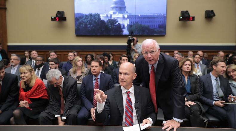 Former Republican Sen. Saxby Chambliss advises former Equifax CEO Richard Smith before he testifies to the House Energy and Commerce Committee on Oct. 3, 2017. (Photo by Chip Somodevilla/Getty Images)