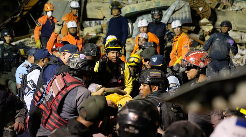 Rescue workers search through the rubble of a collapsed building after earthquake in Caracas, Venezuela, Wednesday, June 24, 2026. (AP Photo/Ariana Cubillos)
