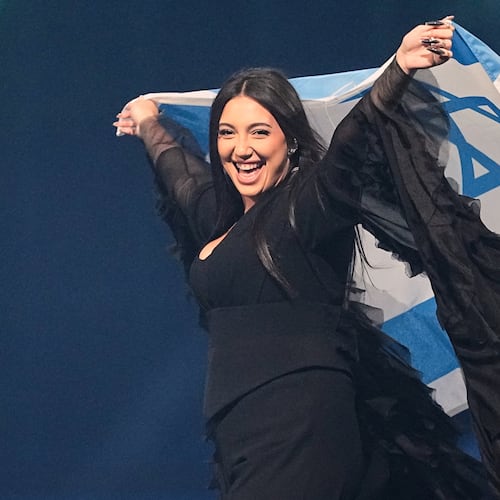 FILE - Singer Yuval Raphael, from Israel, holds the national flag during a dress rehearsal for the Grand Final of the 69th Eurovision Song Contest, May 16, 2025, in Basel, Switzerland. (AP Photo/Martin Meissner, File)
