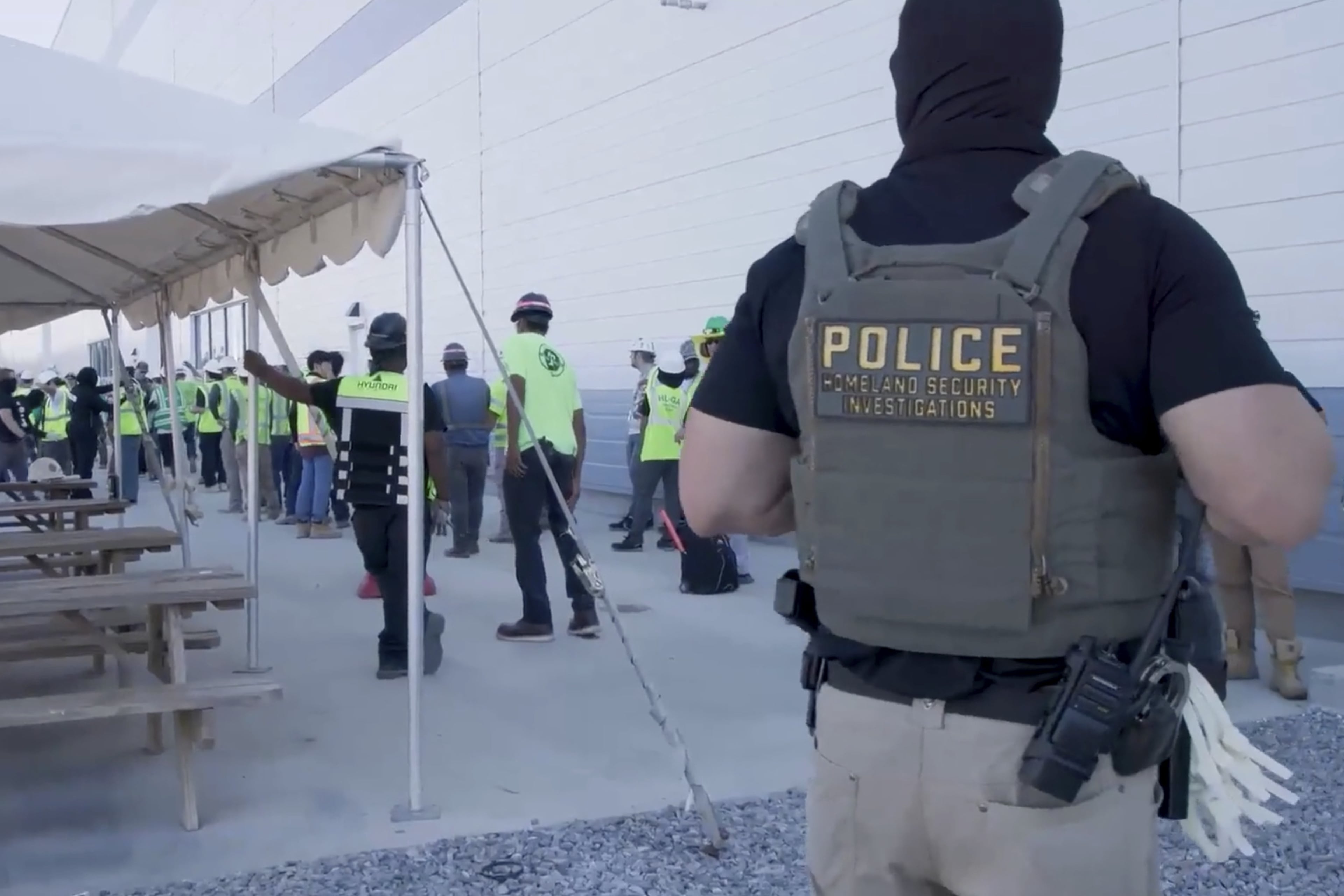 ICE officials escort workers outside the Hyundai Motor Group’s electric vehicle plant, Thursday, Sept. 4, 2025, in Ellabell. (Corey Bullard/U.S. Immigration and Customs Enforcement via AP)