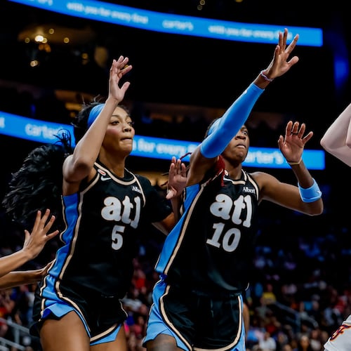 Atlanta Dream forward Angel Reese (left) and guard Rhyne Howard defend against Indiana Fever guard Caitlin Clark during Sunday's WNBA game in Atlanta. (Erik S. Lesser for the AJC)