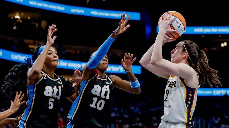 Atlanta Dream forward Angel Reese (left) and guard Rhyne Howard defend against Indiana Fever guard Caitlin Clark during Sunday's WNBA game in Atlanta. (Erik S. Lesser for the AJC)