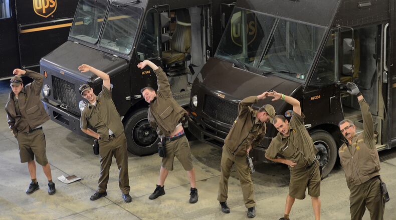 In this file photo, drivers do light stretching before getting the daily performance update and safety briefing before heading out with the day's deliveries at the UPS depot on Nov. 3, 2015 in Jackson, Pa. (Bob Donaldson/Pittsburgh Post-Gazette/TNS)
