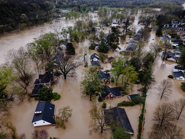 In an aerial view, a flooded neighborhood is seen on Sunday, April 6, 2025, in Frankfort, Ky. (AP Photo/Jon Cherry)