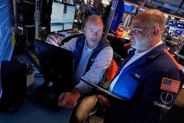 Trades Peter Mancuso, left, and Phil Quartuccio work on the floor of the New York Stock Exchange, Friday, June 27, 2025. (AP Photo/Richard Drew)