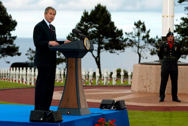 FILE - President George W. Bush addresses veterans and others gathered at the Normandy American Cemetery in Colleville-sur-Mer, France, Monday, May 27, 2002. (AP Photo/Doug Mills, File)