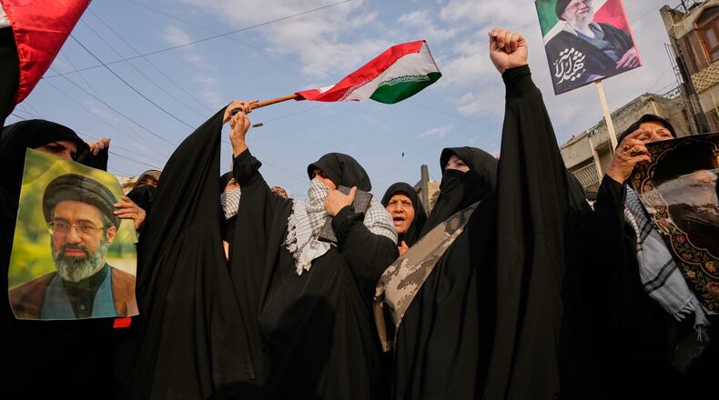 Iraqi Muslim women hold portraits of Iran's late Supreme Leader Ayatollah Ali Khamenei and his son Ayatollah Mojtaba Khamenei, during a protest against U.S. and Israeli attacks on multiple cities across Iran, in Baghdad, Iraq, Saturday, April 25, 2026. (AP Photo/Hadi Mizban)
