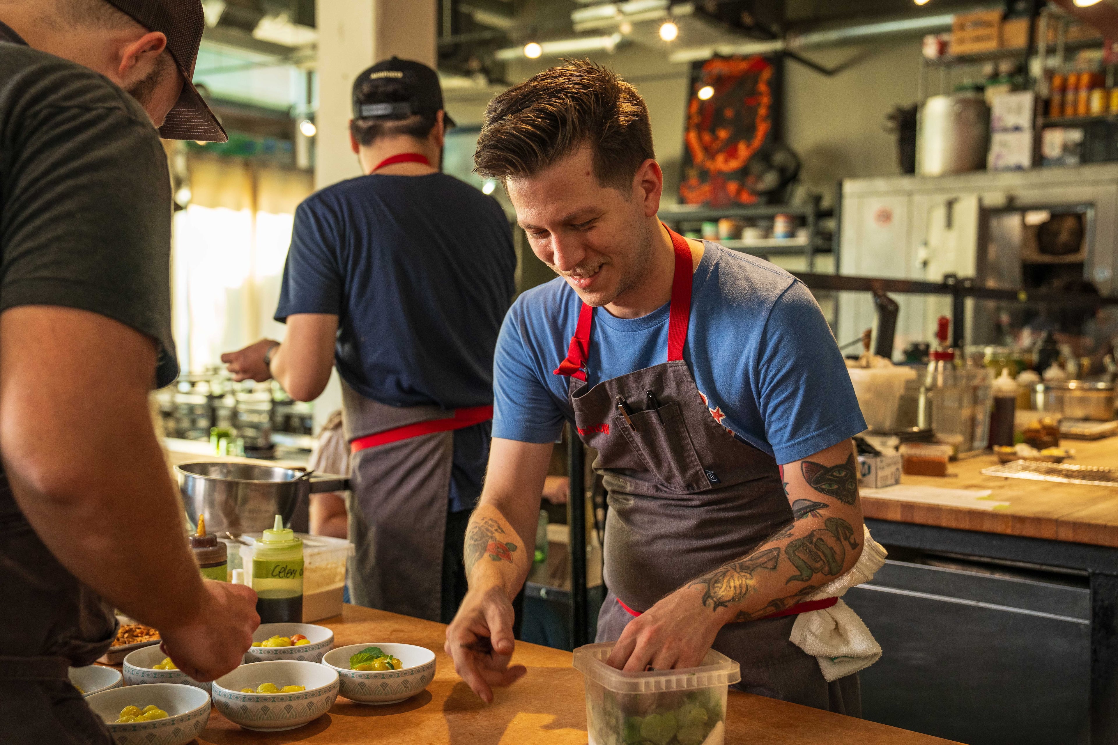 The chefs at Gunshow make a playground out of the open kitchen as they turn local and regional products into small-plate Southern vittles. (Courtesy of Blake Studwell)