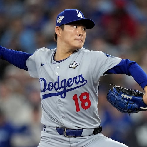 Los Angeles Dodgers pitcher Yoshinobu Yamamoto (18) delivers during the sixth inning in Game 2 of baseball's World Series against the Toronto Blue Jays, Saturday, Oct. 25, 2025, in Toronto. (Nathan Denette/The Canadian Press via AP)