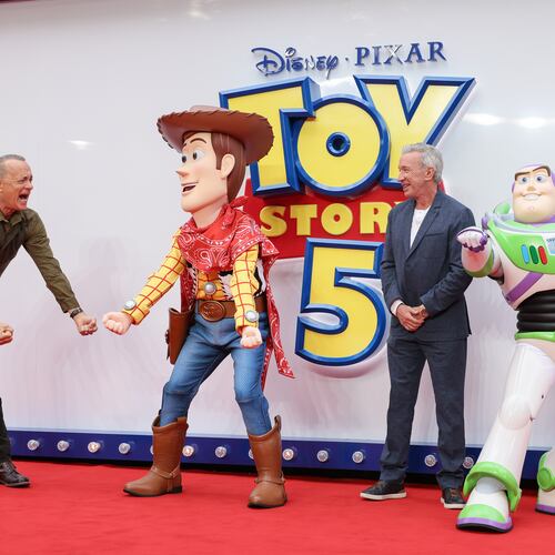 Tom Hanks, left, and Tim Allen pose for photographers with people costumed as the characters Woody and Buzz Lightyear upon arrival at a launch event for the film 'Toy Story 5' on Thursday, May 28, 2026, in London. (Photo by Millie Turner/Invision/AP)