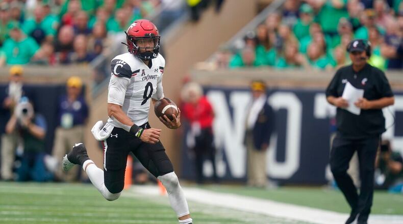 Cincinnati quarterback Desmond Ridder (9) runs during the second half of an NCAA college football game against Notre Dame, Saturday, Oct. 2, 2021, in South Bend, Ind. Cincinnati won 24-13. (AP Photo/Darron Cummings)