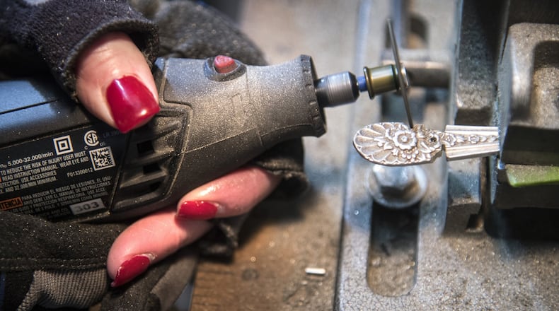 Terry Rathbun, of Roots of Silver, uses a rotary tool to remove the ornate end of a silverware spoon as she creates jewelry on Wednesday, Jan. 31, 2018, in Liberty Lake, Wash. (Dan Pelle/The Spokesman-Review/TNS)