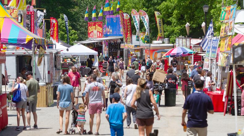 Fairgoers walk around the rides and food venues during the 20th annual Lemonade Days Festival on Sunday, April 28, 2019, in Dunwoody. Lemonade Days is the largest annual fundraising event for the Dunwoody Preservation Trust. All proceeds are used within the community for historic preservation and education. STEVE SCHAEFER / SPECIAL TO THE AJC