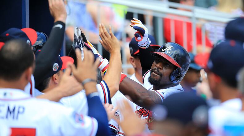 Brandon Phillips (center) of the Braves celebrates a solo home run against the Mets at SunTrust Park on June 10, 2017. (Photo by Daniel Shirey/Getty Images)