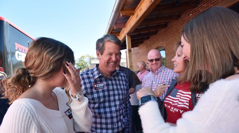 October 29, 2018 Madison - GOP gubernatorial candidate Brian Kemp smiles as he talks with his supporters (from left) Meg Hawkins, Lisa Talaga and Lauren Talaga at Amici Madison Restaurant during The Georgia Republican Party "Road to Victory" Bus Tour on Monday, October 29, 2018. Georgiaâs gubernatorial candidates are spending the final days of the race traveling across the state in search of votes. HYOSUB SHIN / HSHIN@AJC.COM