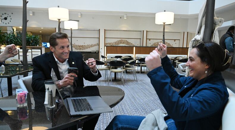 U.S. Rep. Rich McCormick reacts with Brittany McGivern (right) after he successfully made a call to encourage to vote for presidential candidate Florida Gov. Ron DeSantis at a hotel lobby, Sunday, January 14, 2024, in West Des Moines, Iowa. (Hyosub Shin / Hyosub.Shin@ajc.com)