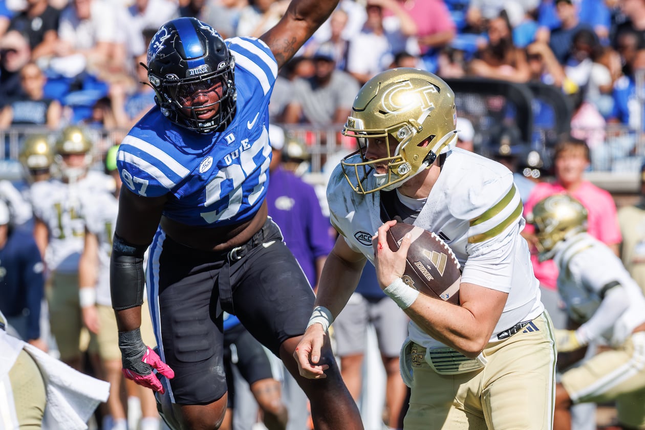 Georgia Tech's Haynes King (right) carries the ball past Duke's Wesley Williams durring the second half  Saturday, Oct. 18, 2025, in Durham, N.C. King threw for 205 yards and rushed fo 120 in the Yellow Jackets' 27-18 win. (AP Photo/Ben McKeown)