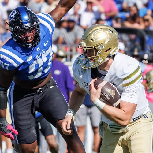 Georgia Tech's Haynes King (right) carries the ball past Duke's Wesley Williams durring the second half  Saturday, Oct. 18, 2025, in Durham, N.C. King threw for 205 yards and rushed fo 120 in the Yellow Jackets' 27-18 win. (AP Photo/Ben McKeown)