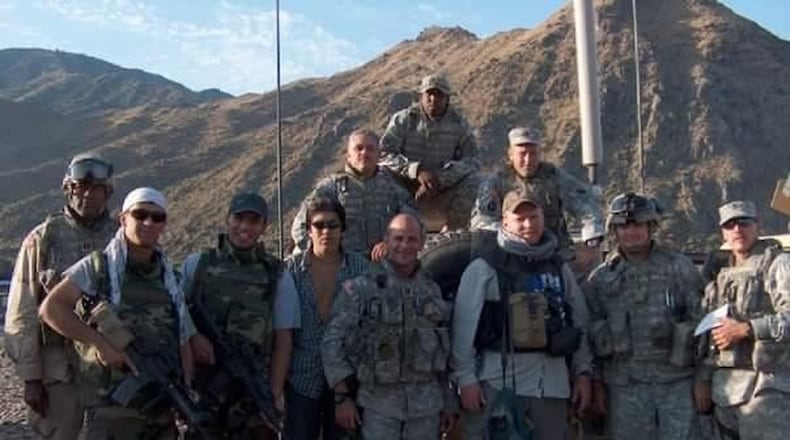 Retired Sgt. 1st Class Leroy Strickland (top) calls former Afghan interpreter Gul Agha, third from left, his brother.