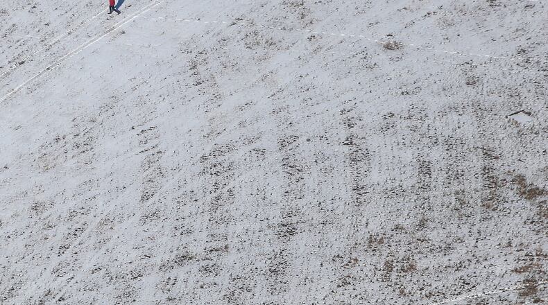 February 13, 2014: A person walks across a snow-covered field between Atlanta and Augusta on Thursday afternoon February 13, 2014. BEN GRAY / BGRAY@AJC.COM