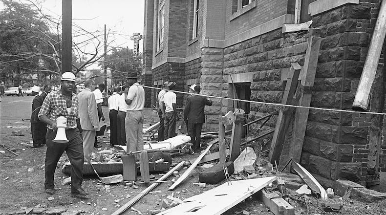 In a Sept. 15, 1963 file photo, investigators work outside the 16th Street Baptist Church in Birmingham, Ala., following an explosion that killed four young girls. Three Ku Klux Klansmen were convicted in the bombing years later. (AP Photo/File)