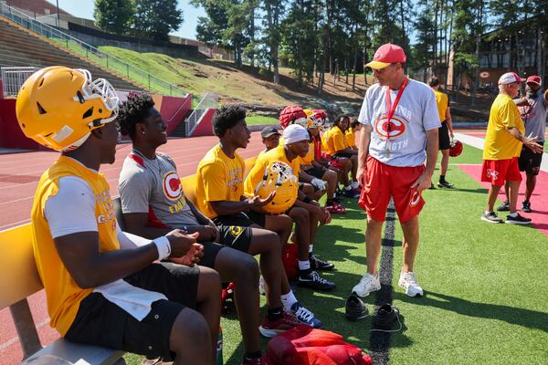 Clarke Central high school baseball and football coach David Perno (right) is battling cancer. He says it's made him into a more loving leader. (Arvin Temkar/AJC)