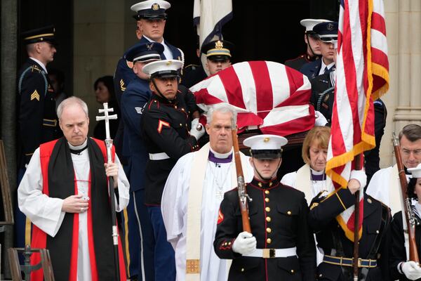 The flag-draped casket of former Vice President Dick Cheney was carried out of the Washington National Cathedral on Thursday. (Mark Schiefelbein/AP)