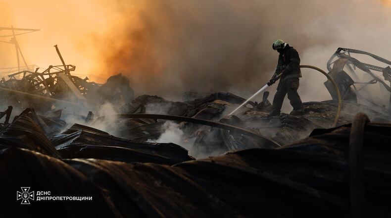 In this photo provided by the Ukrainian Emergency Service, a firefighter puts out a fire following a Russian missile attack in Dnipropetrovsk region, Ukraine, Tuesday, Aug. 4, 2026. (Ukrainian Emergency Service via AP)