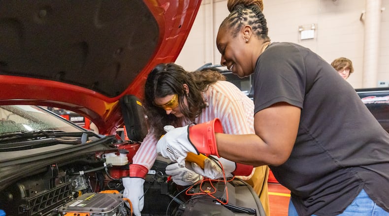 Lorelei Neighbors and Vanessa Walker use a voltage meter on a car at Savannah Technical College on Tuesday, July 16, 2024 in Savannah, GA. (AJC Photo/Katelyn Myrick)