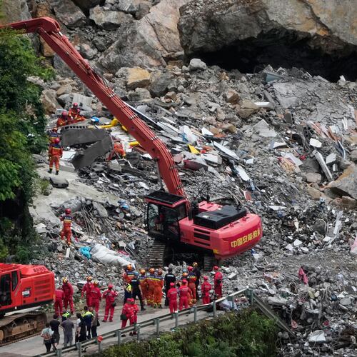 Rescuers use a heavy duty machine to clear the rubble to search for trapped victims at the scene of a landslide in Pengshui County in southwestern China's Chongqing on Saturday, July 18, 2026. (AP Photo/Andy Wong)