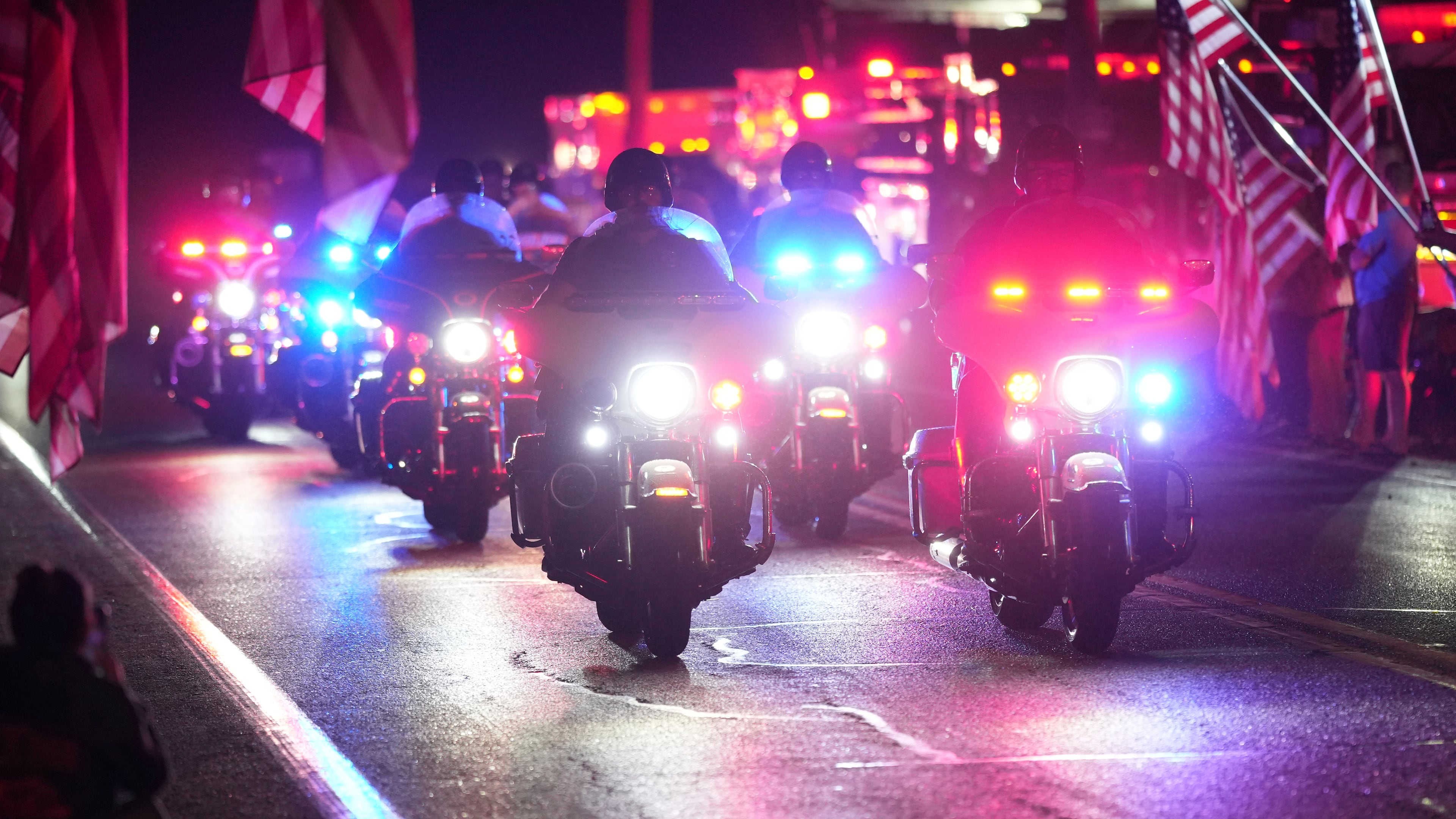 Police officers ride during a procession Wednesday, Sept. 17, 2025, in Spring Grove, Pa., after multiple police officers were shot and killed. (AP Photo/Matt Slocum)