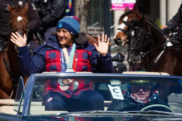 Honorary grand marshal Elana Meyers Taylor waves to the crowd during the Atlanta St. Patrick's Parade in 2022. (Steve Schaefer/AJC 2022)