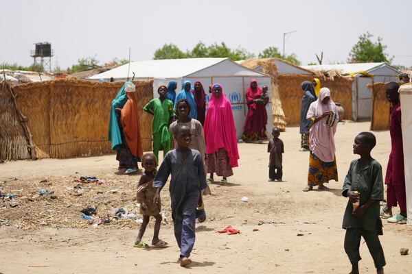 Women and children displaced by Boko haram attacks are seen outside there camp in Dikwa, north east Nigeria, April 29, 2025. (AP Photo/Sunday Alamba)