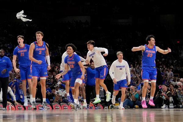 Florida celebrates their win against Auburn in the national semifinals at the Final Four of the NCAA college basketball tournament, Saturday, April 5, 2025, in San Antonio. (AP Photo/Brynn Anderson)