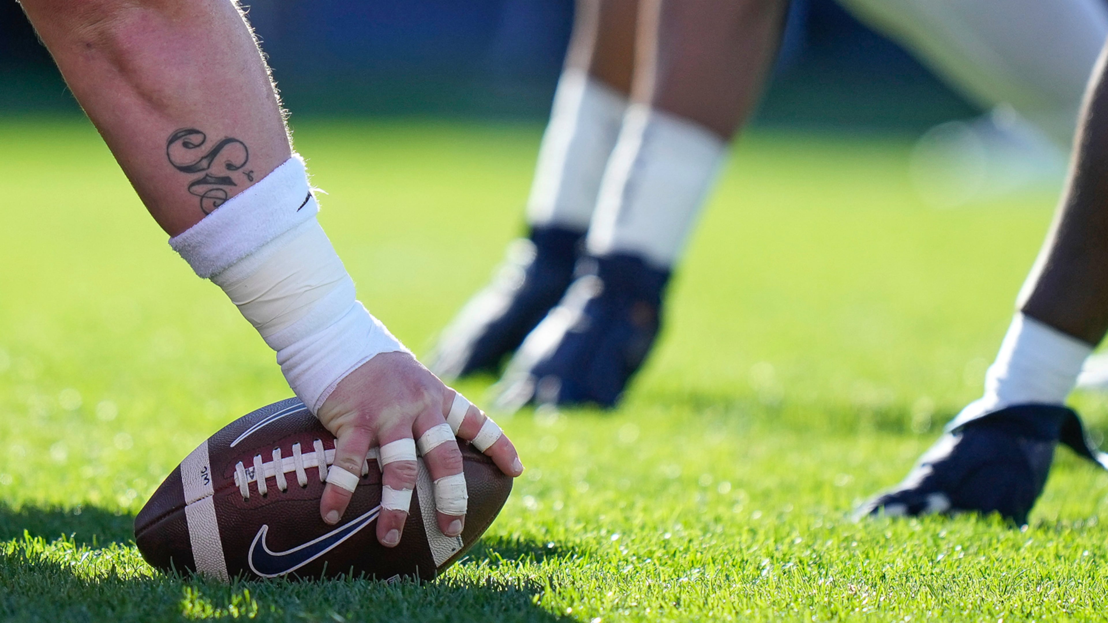 Players line up at the line of scrimmage during the first half of an NCAA college football game in East Hartford, Conn., Saturday, Nov. 12, 2022. (AP Photo /Bryan Woolston, File)