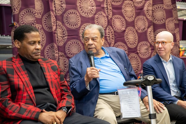 MLK family, including King’s nephew Isaac Farris Jr. (from left), and Ambassador Andrew Young and “King: A Life” author Jonathan Eig discuss the book and their memories of Stockbridge and the stories of 'Daddy King' and the family. This Stockbridge Walmart where the event was held stands on what was once a cotton field where King’s father was a sharecrop farmer.  (Jenni Girtman for the AJC 2023)
