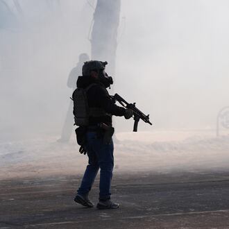 Federal immigration officers deploy tear gas after a shooting in Minneapolis, on Saturday, Jan. 24, 2026. (AP Photo/Abbie Parr)
