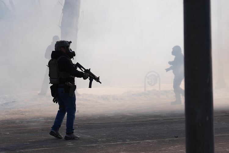 Federal immigration officers deploy tear gas after a shooting in Minneapolis, on Saturday, Jan. 24, 2026. (AP Photo/Abbie Parr)