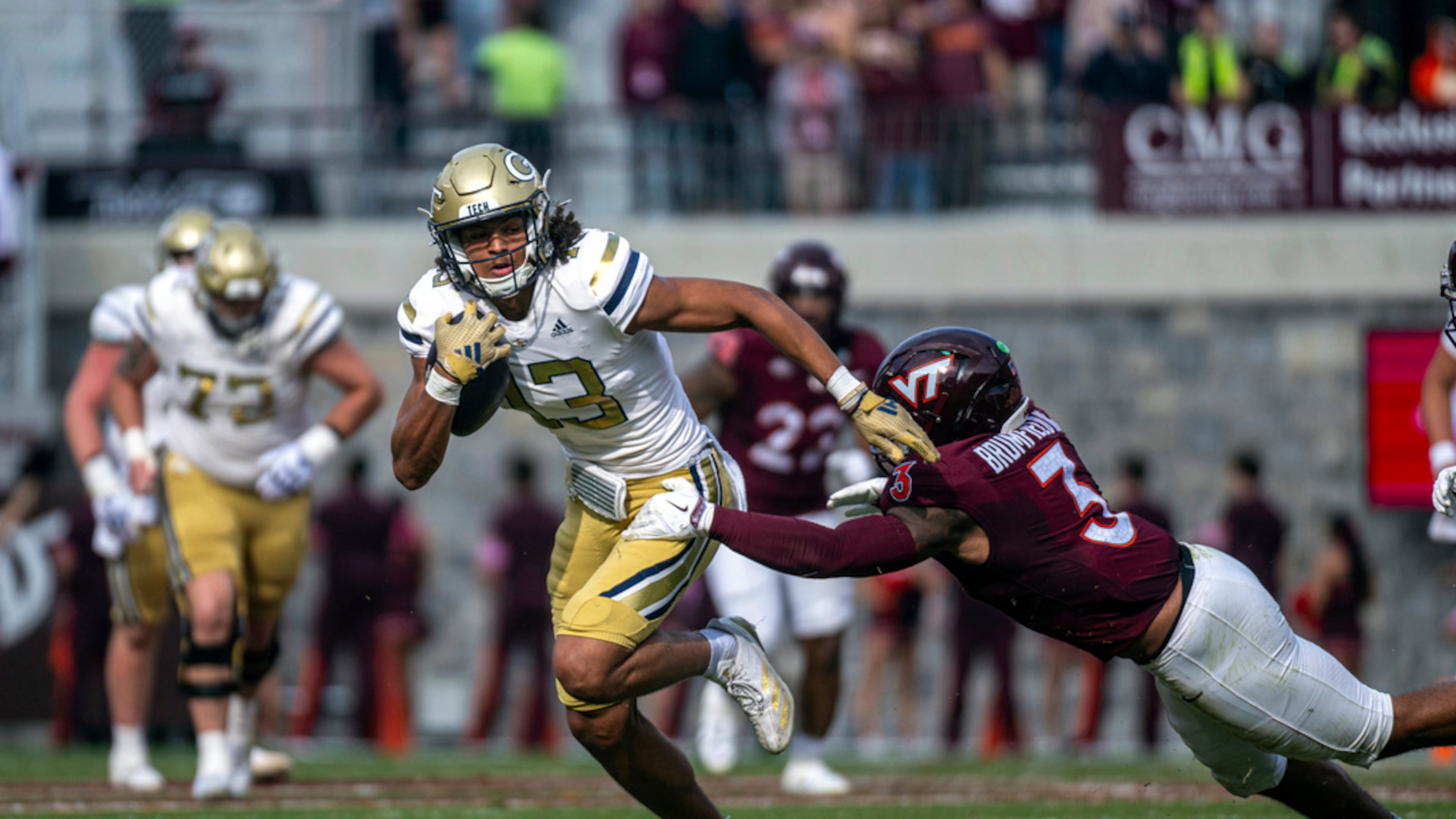 Georgia Tech's Isiah Canion (left) gets by Virginia Tech's Sam Brumfield during the second half of an NCAA college football game in Blacksburg, Va. (Robert Simmons/AP 2024)