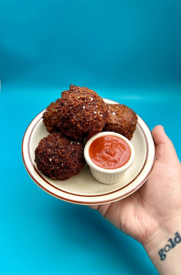 Fried arancini bites served with a red dipping sauce from Fool’s Errand.