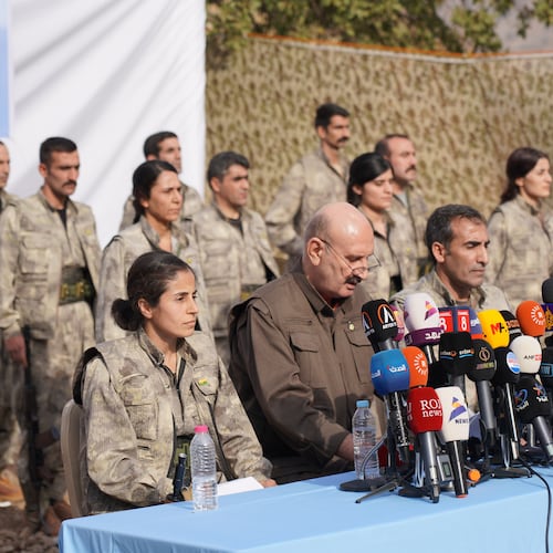 Kurdistan Workers' Party (PKK) fighters, who reportedly withdrew from Turkey with their weapons, stand to attention during a ceremony in the Qandil area of northern, Iraq, Sunday, Oct 26, 2025. (AP Photo/Rashid Yahya)
