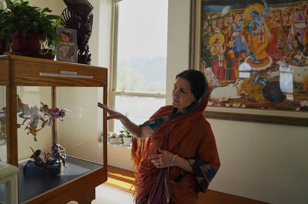 Krishna Presthaya points to a scene depicting "The Second Chance," at The Shri Shri Radha Krishna Temple in Spanish Fork, Utah, on Friday, April 25, 2025. (AP Photo/Jessie Wardarski)