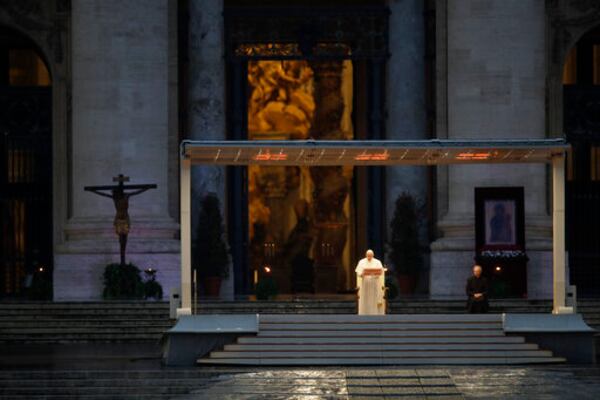 FILE - Pope Francis, standing alone at center, delivers an Urbi et orbi prayer from the empty St. Peter's Square, at the Vatican, Friday, March 27, 2020. “We have realized that we are on the same boat, all of us fragile and disoriented, but at the same time, important and needed, all of us called to row together, each of us in need of comforting the other.” (AP Photo/Alessandra Tarantino, File)