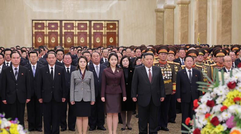 In this photo provided by the North Korean government, leader Kim Jong Un, center right, his wife Ri Sol Ju, third left, and their daughter, center, believed to be named Kim Ju Ae, visit Kumsusan Palace of the Sun in Pyongyang, North Korea, Thursday, Jan. 1, 2026. Independent journalists were not given access to cover the event depicted in this image distributed by the North Korean government. The content of this image is as provided and cannot be independently verified. Korean language watermark on image as provided by source reads: "KCNA" which is the abbreviation for Korean Central News Agency. (Korean Central News Agency/Korea News Service via AP)