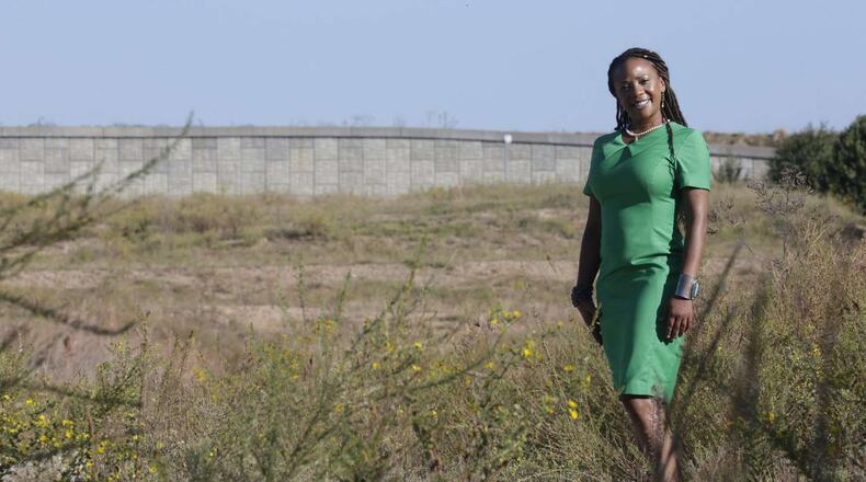 Liza Milagro, the airport’s senior sustainability leader, at the site of the future Green Acres airport composting and recycling facility. The project has been on the drawing board for years but has been slowed by contracting issues. BOB ANDRES /BANDRES@AJC.COM