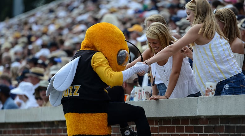Georgia Tech fans help team mascot Buzz into the stands by fans during the first half of an NCAA college football game against Pittsburgh, Saturday, Sept. 23, 2017, in Atlanta. (AP Photo/Jon Barash)