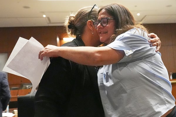Elizabeth Turnipseed, right, and Melissa Burke, victim specialist of Lake County State's Attorney, hug after reading a victim impact statement during the sentencing hearing for Robert E. Crimo III., at the Lake County Courthouse, in Waukegan, Ill., Wednesday, April 23, 2025. (AP Photo/Nam Y. Huh, Pool)