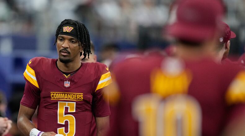 Washington Commanders quarterback Jayden Daniels walks on the sideline during the first half of an NFL football game against the Dallas Cowboys Sunday, Oct. 19, 2025, in Arlington, Texas. (AP Photo/Tony Gutierrez)