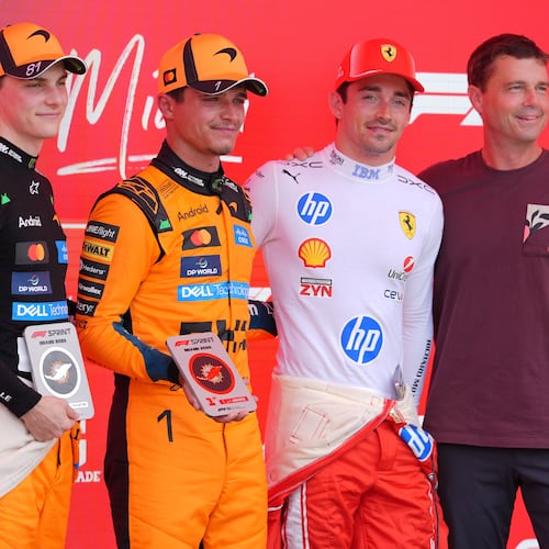 Astronaut Reid Wiseman, right, poses for a photo with (from left) third place finisher McLaren driver Oscar Piastri of Australia, first place finisher McLaren driver Lando Norris of Britain, and third place finisher Ferrari driver Charles Leclerc of Monaco after a sprint auto race at the Miami Formula One Grand Prix, Saturday, May 2, 2026, in Miami Gardens, Fla. (AP Photo/Rebecca Blackwell)